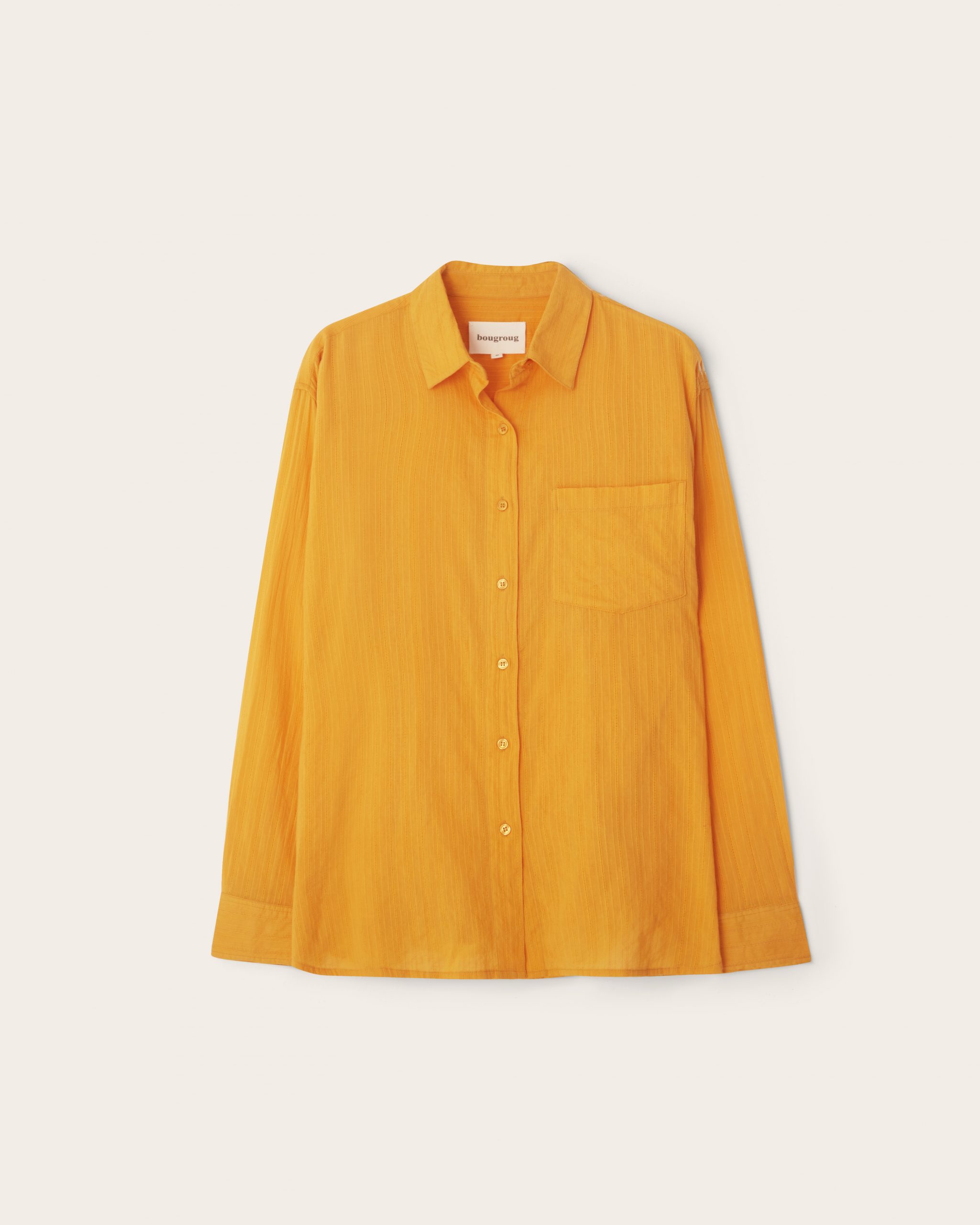 Orange long sleeve shirt in textured cotton dobby fabric handmade in Morocco and India. Genderless bougroug style. Designed by Anwar Bougroug